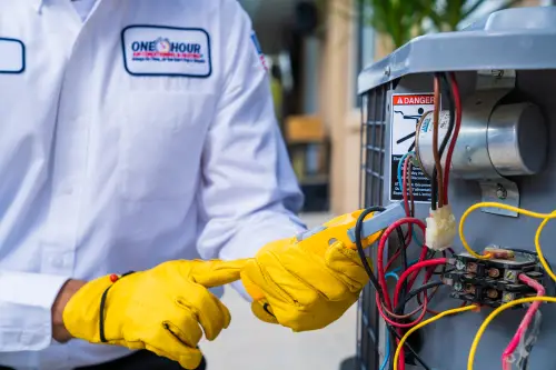 One Hour Air Conditioning & Heating technician diagnosing an HVAC unit in Birmingham, AL, ensuring efficient air conditioning system performance and reliability.